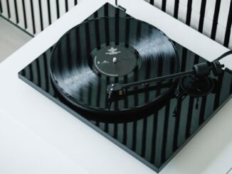 An angled view of a black Pro-Ject E1.2 turntable atop a white unit