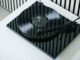 An angled view of a black Pro-Ject E1.2 turntable atop a white unit