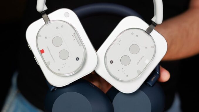 Nothing Headphone (1) and Sony WH-1000XM6 held against the camera, showing the backs of the earcups