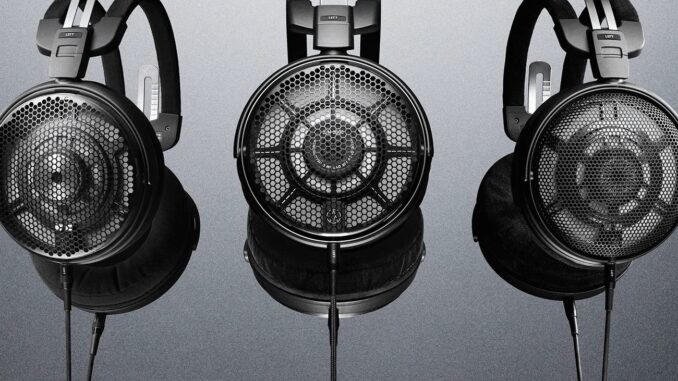 A Renowned Japanese Hi-Fi Brand's Newest Headphones Are for Elite... Three black open-back headphones with mesh ear cups and adjustable headbands against a gray gradient background.