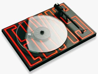Black turntable with a transparent platter and red LED maze pattern on the base.