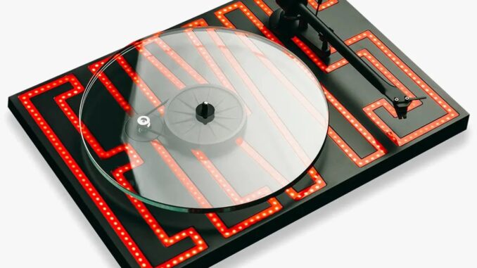 Pro-Ject's New Audiophile Turntable Looks Absolutely Mesmerizing Black turntable with a transparent platter and red LED maze pattern on the base.